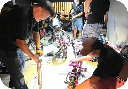 HOPE Technik Staff volunteers working to refurbish a children bike